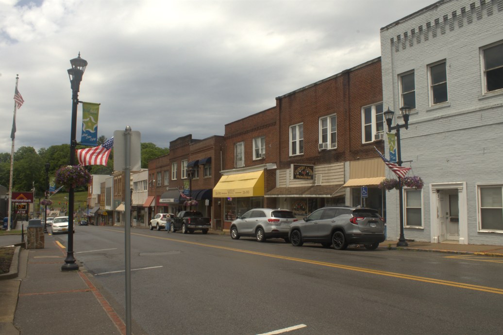 Storefronts and on-street parking along a street in Bluefield, Virginia.
