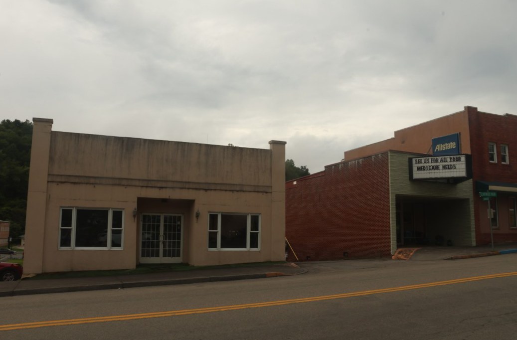 Downtown building frontages beside a sidewalk in Clintwood.